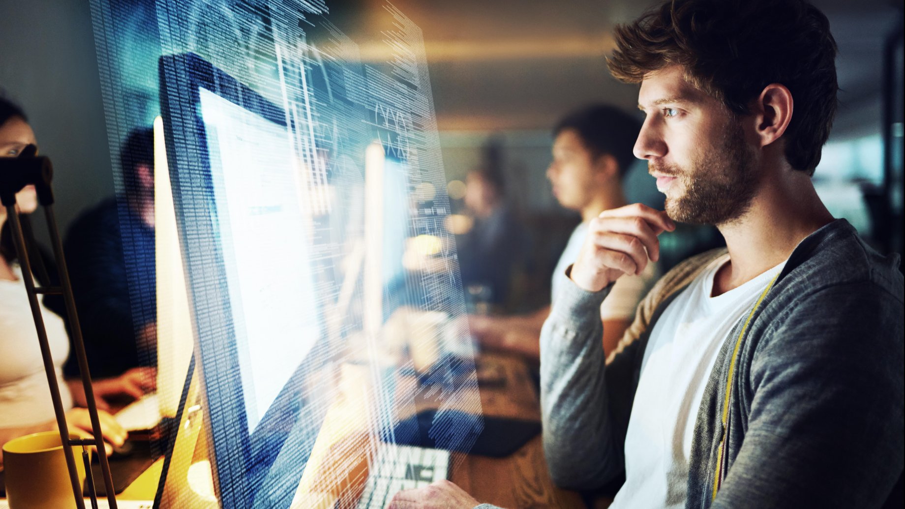 Man working in an office in front of a screen