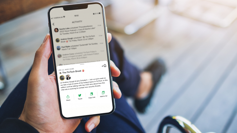 Someone holding a smartphone with clubhouse app