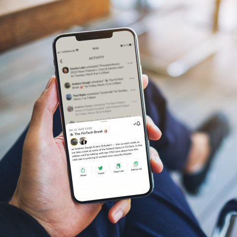 Someone holding a smartphone with clubhouse app